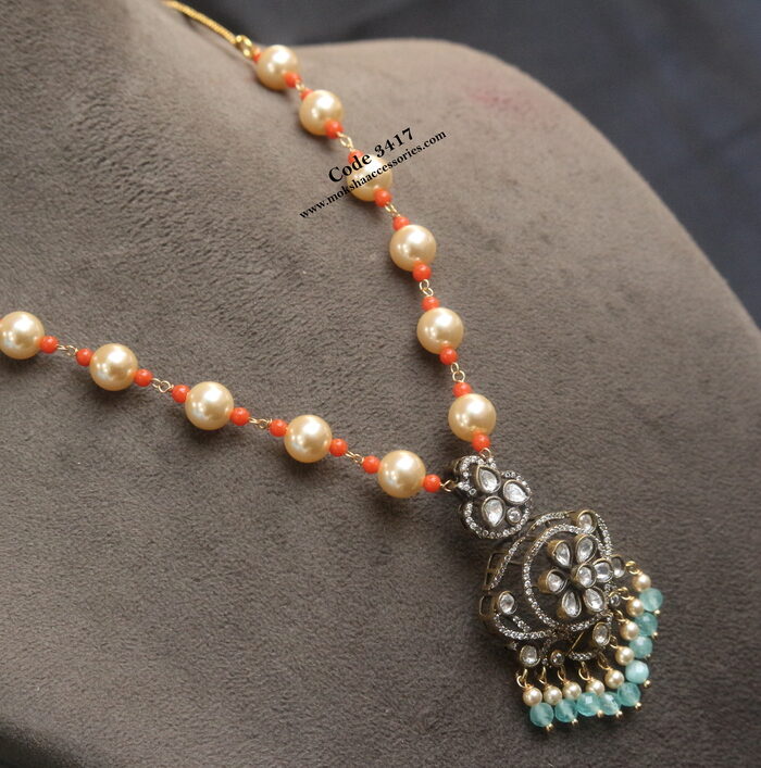 Mozonite stone pendant with sarvoski and coral mala