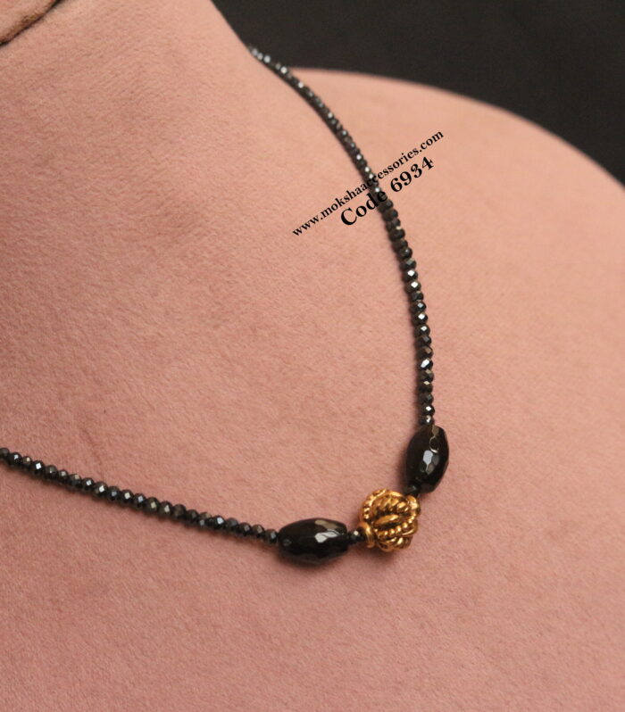 Black beads with antique gold ball