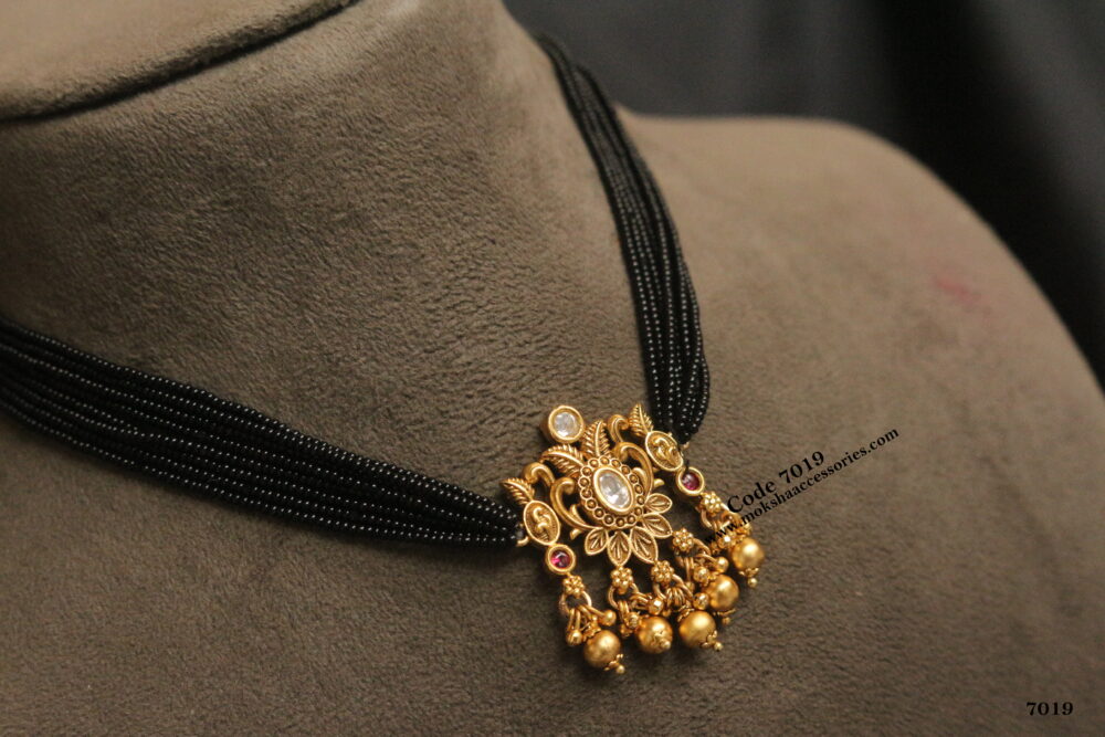 Black beads with antique gold pendant