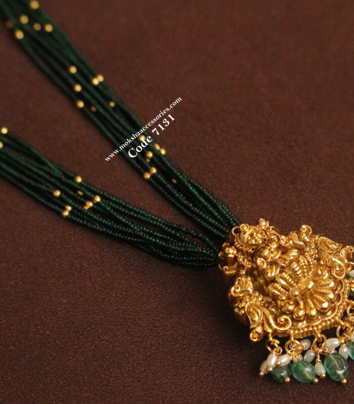 Gold lakshmi pendant with green and gold balls
