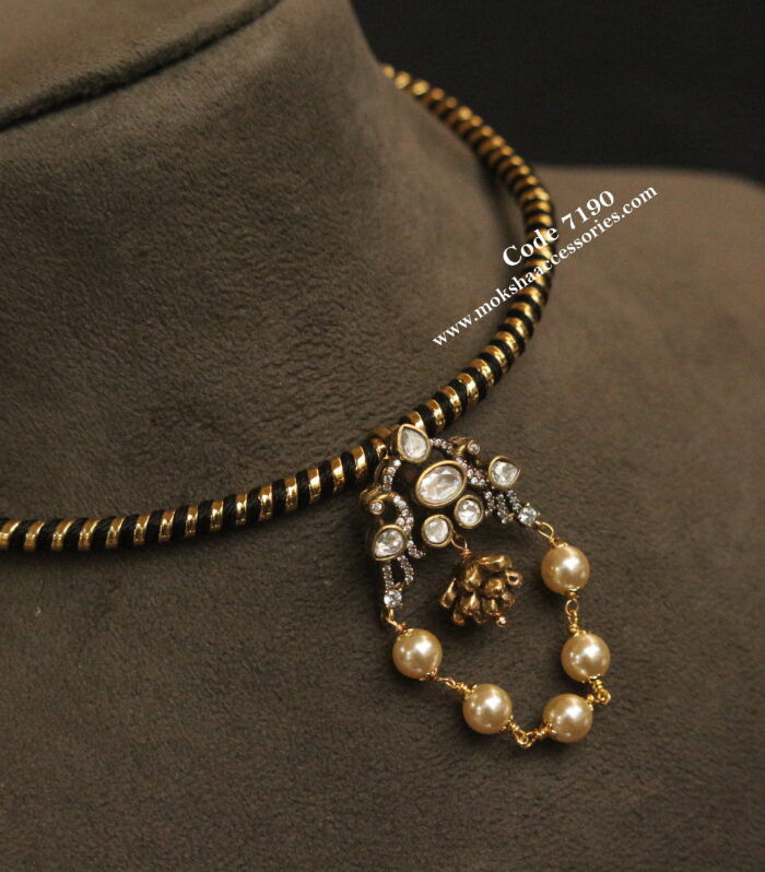 Black hasli with antique gold pendant