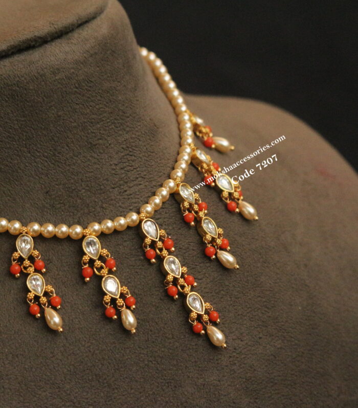 Sarvoski pearl choker with jadaukundan pendants and sarvoski pearl drops
