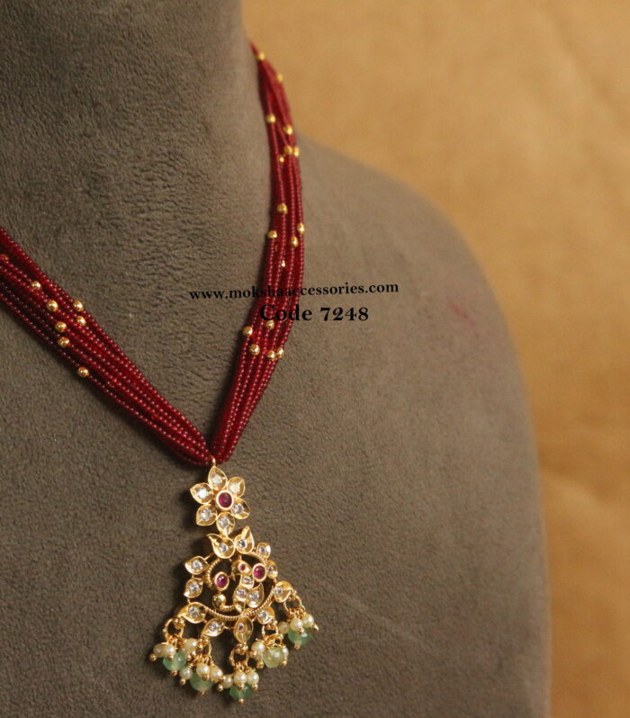 Antique gold pendant with marroon and gold balls mala