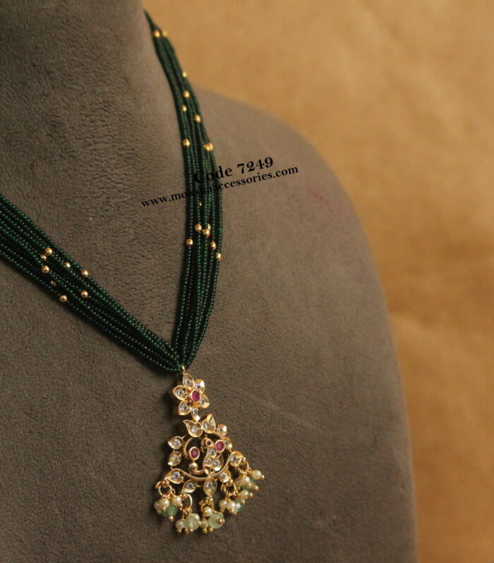 Antique gold pendant with green and gold balls mala