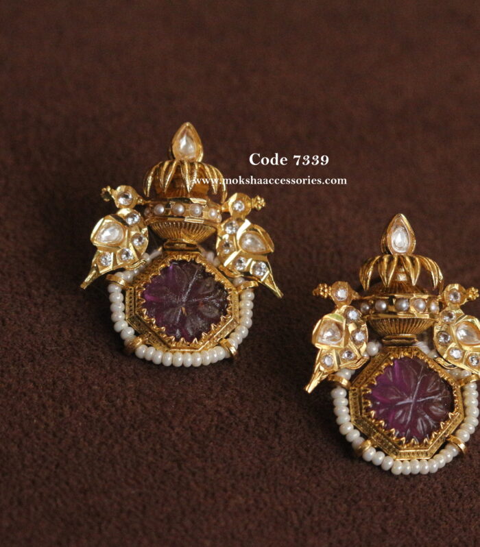 Earrings with purple carving stone