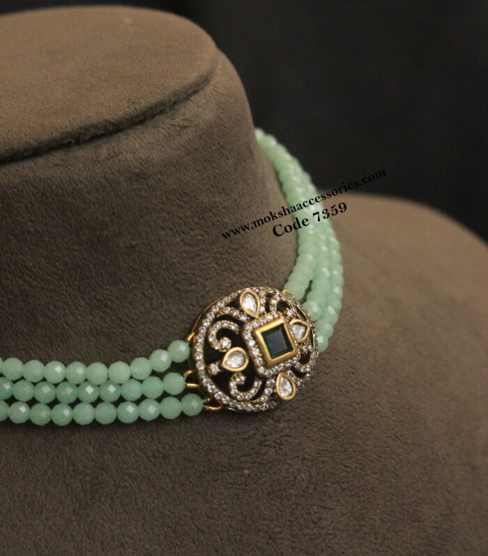 Antique gold pendant with green stone beads