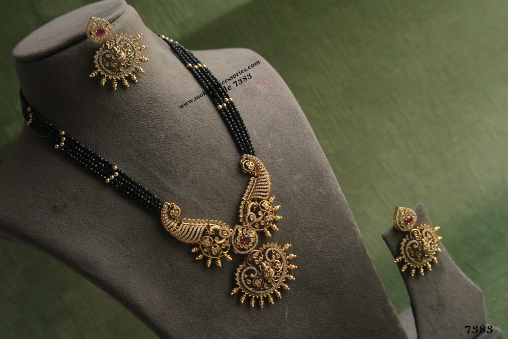 Black beads with gold balls and antique gold pendant set
