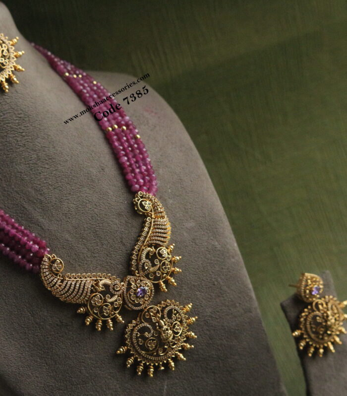 Antique gold pendant with pink beads