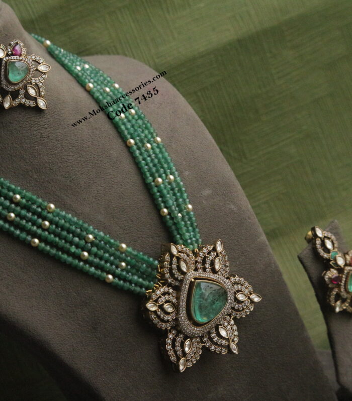 Mozonite stone pendant set with emerald and pearls