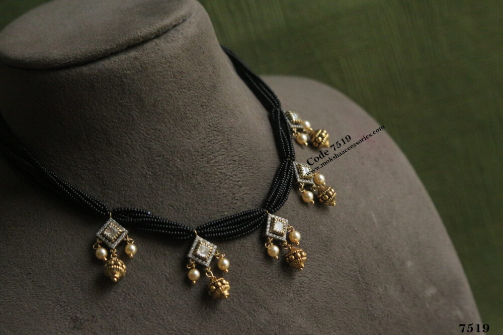 Antique gold pendants with black beads