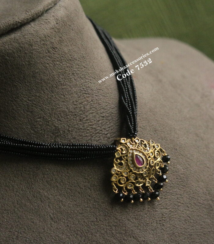 Antique pendant with black beads