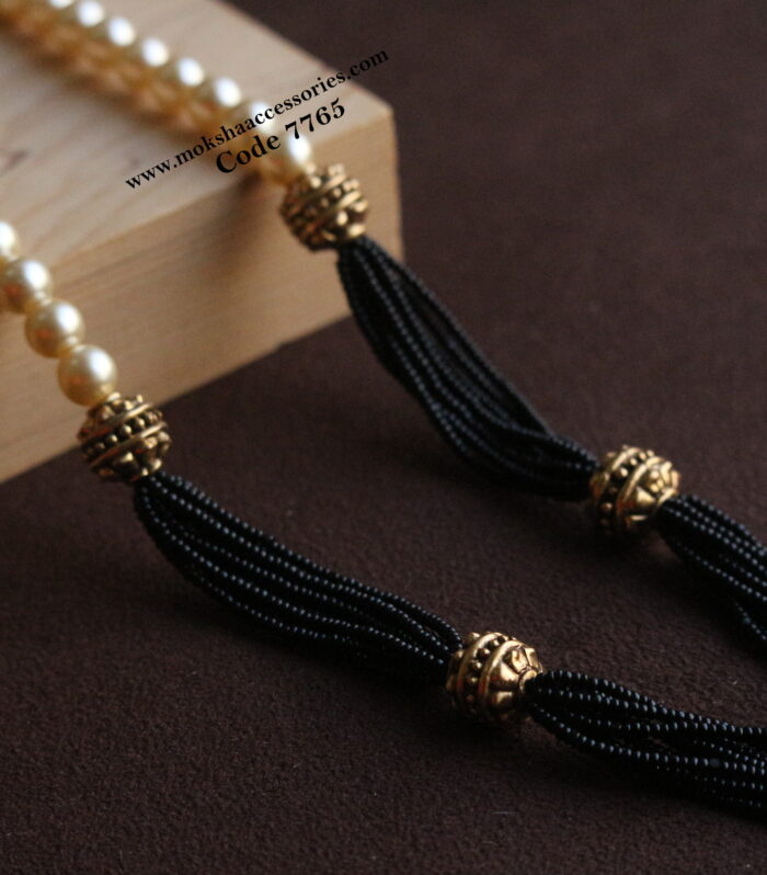 Black beads with antique gold balls and sarvoski pearl