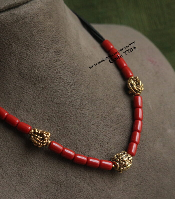 Coral beads with antique gold balls and black beads