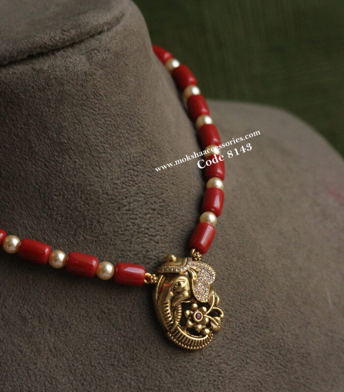 Antique gold elephant pendant with coral and sarvoski pearls