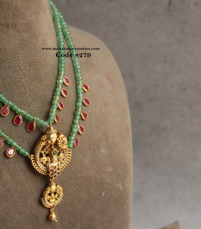 Gold pendant with emerald beads and ruby drops