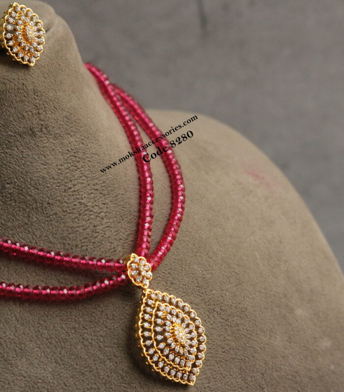 Diamond alike pendant set with ruby beads