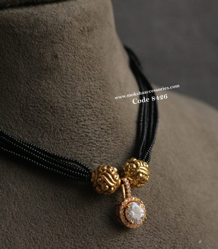 Diamond alike pendant with black beads and antique gold balls