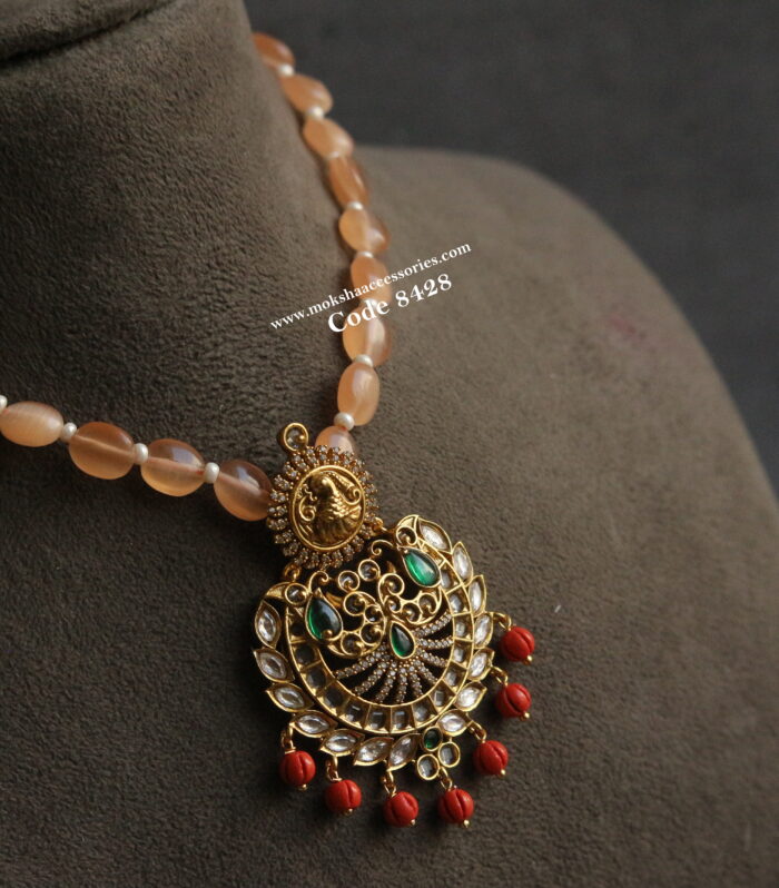 Antique gold pendant with orange beads