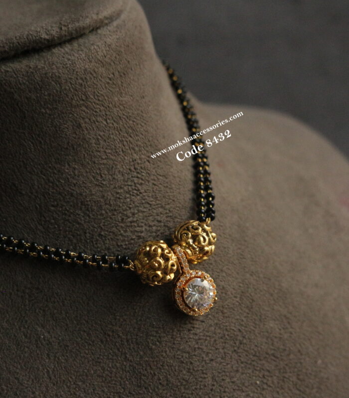 CZ pendant with antique gold balls and black beads