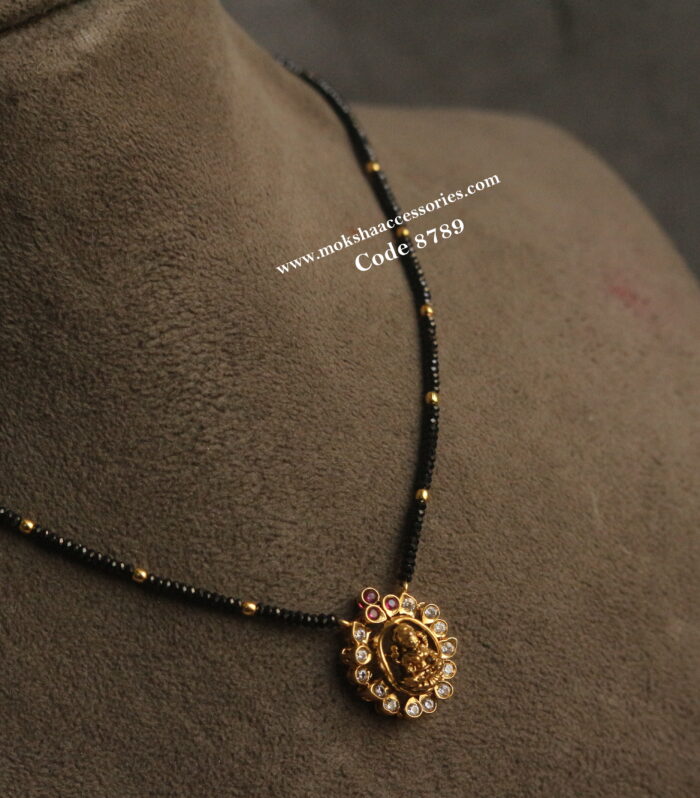 Black beads with gold balls and cz lakshmi devi pendant
