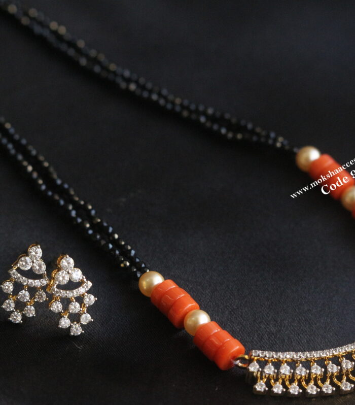 Diamond alike pendant set with coral and black beads