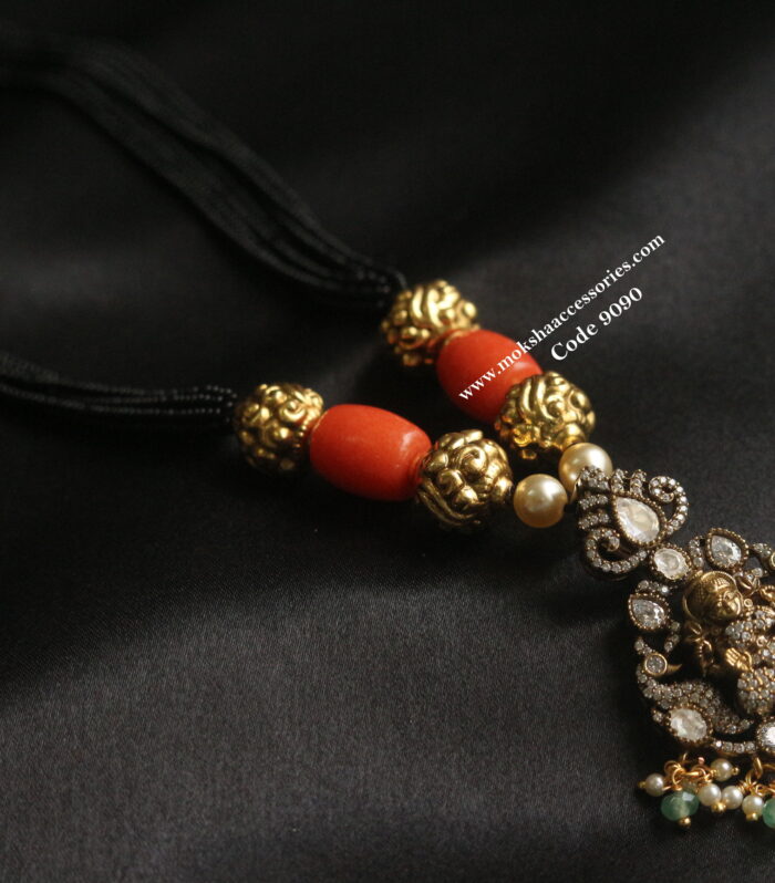Lakshmi devi pendant with coral and black beads