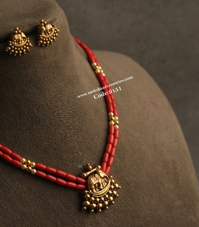 Nakshi gold pendant set with corals and sarovski pearls