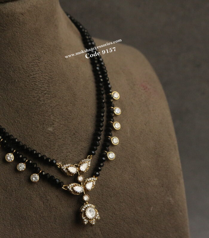 Mozonite stone pendant with black beads and cz drops