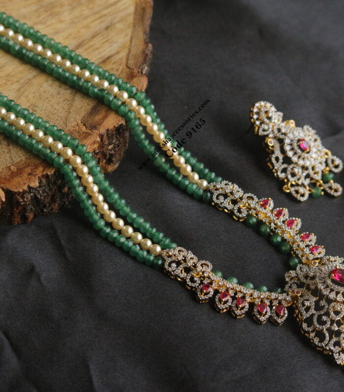 Diamond alike pendant set with emerald and sarvoski pearls