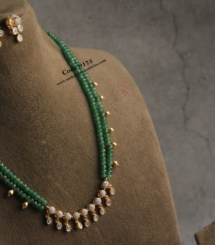 CZ pendant set with emerald beads and gold balls