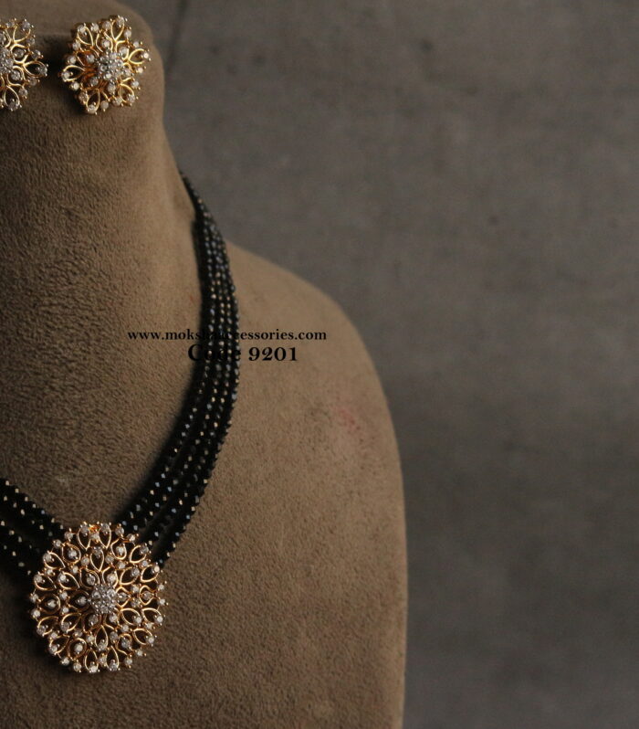 Diamond alike pendant set with black beads