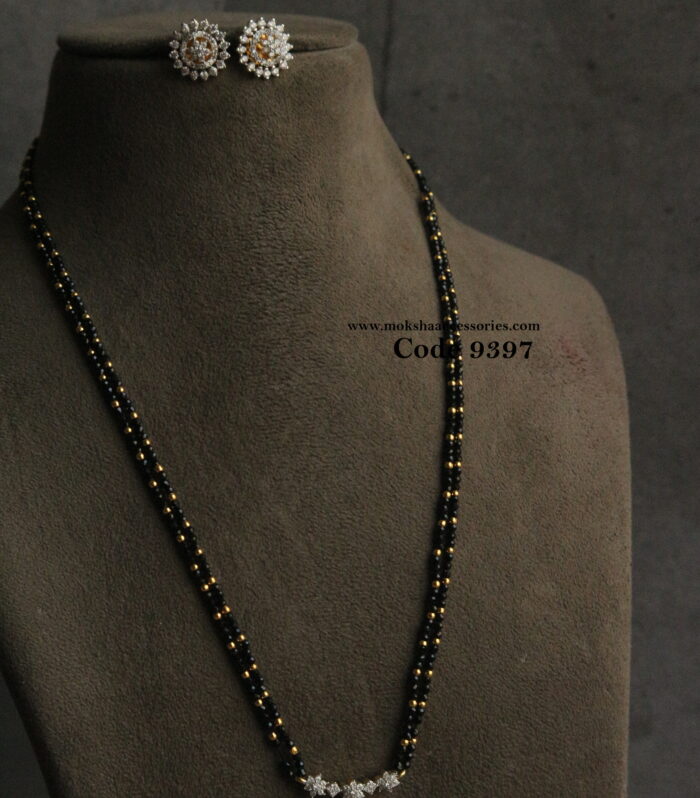Diamond alike pendant set with black beads and gold balls