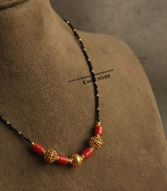 Black beads and corals with antique gold balls