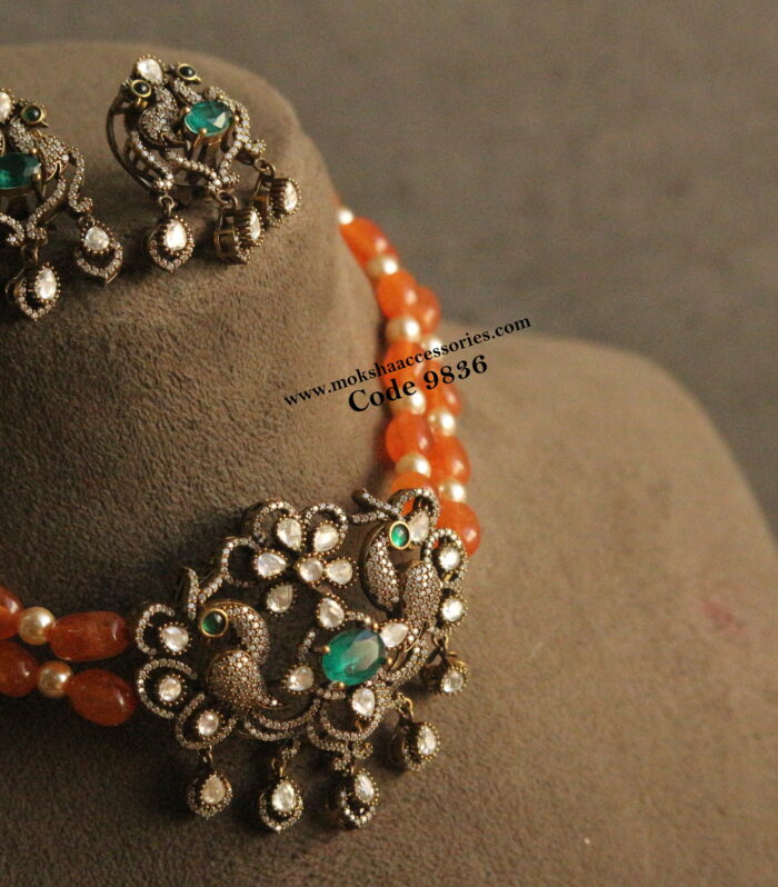 Mozonite stone pendant set with orange agates and sarvoski pearls