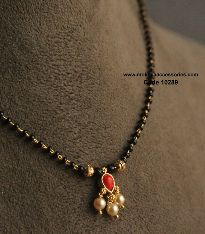 Coral pendant with gold balls and black beads