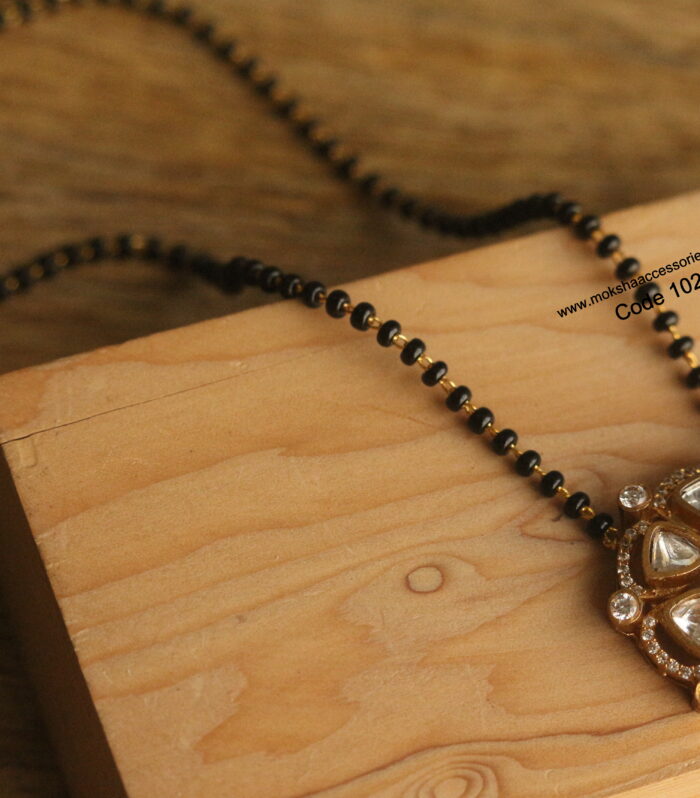 Mozonite stone pendant with black beads