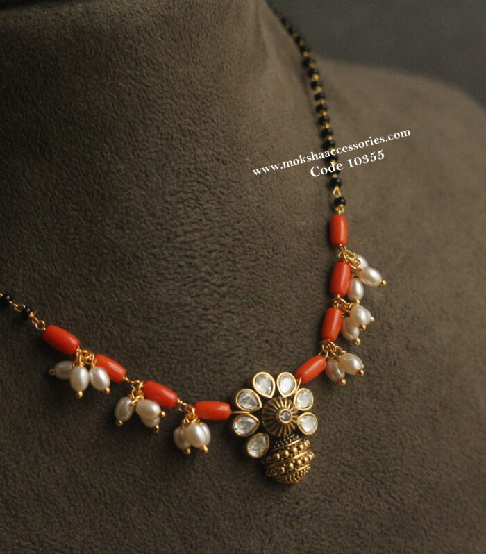 Mozonite stone pendant with corals, pearls and black beads