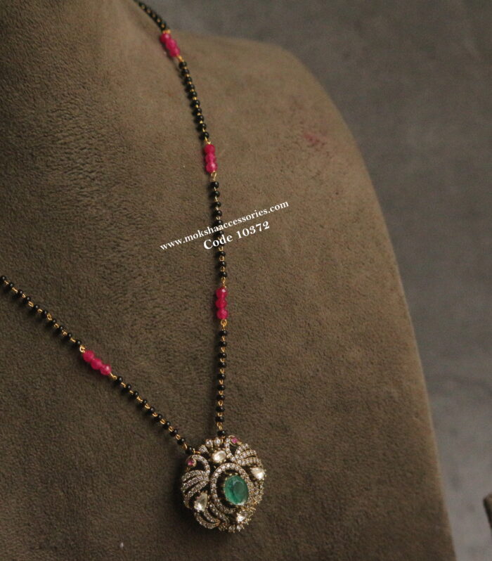 Mozonite stone pendant with black beads and rubies