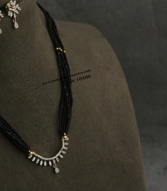 Diamond alike pendant set with black beads and gold balls