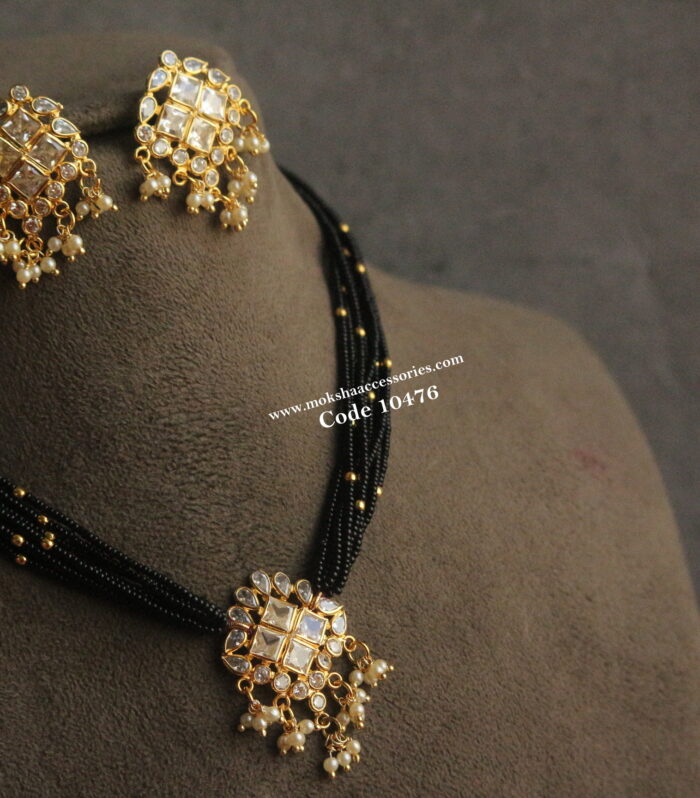 Polki pendant set with black beads and gold balls