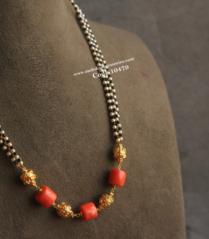 Coral, gold balls, black beads and sarvoski pearl mala