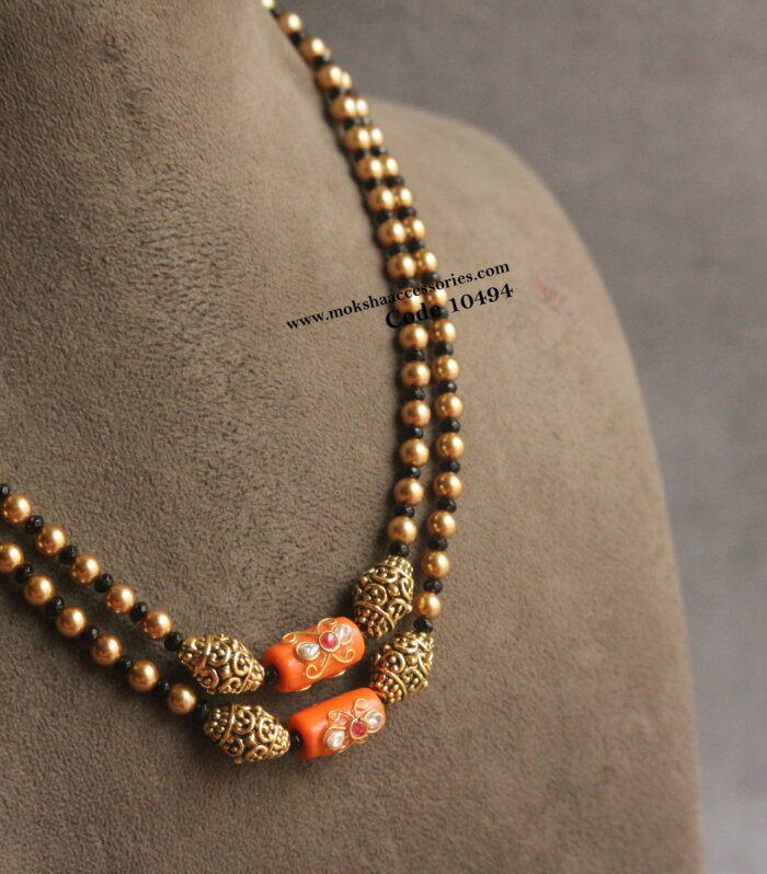 Coral, nakshi balls, sarvoski pearl and black beads mala