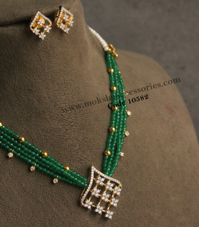 Diamond  alike pendant set with onyx beads, CZ drops, gold balls and pearls