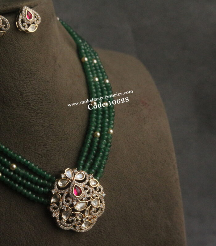 Kundan pendant set with emerald beads and sarvoski pearls