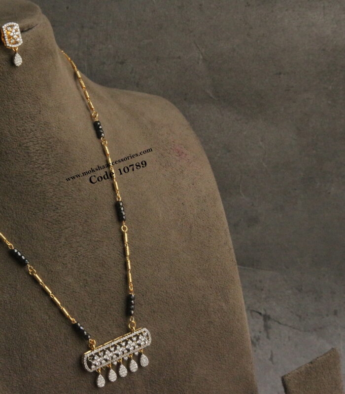 Diamond alike pendant set with black beads and gold chain