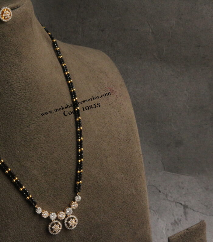 Diamond alike pendant set with black beads and gold balls