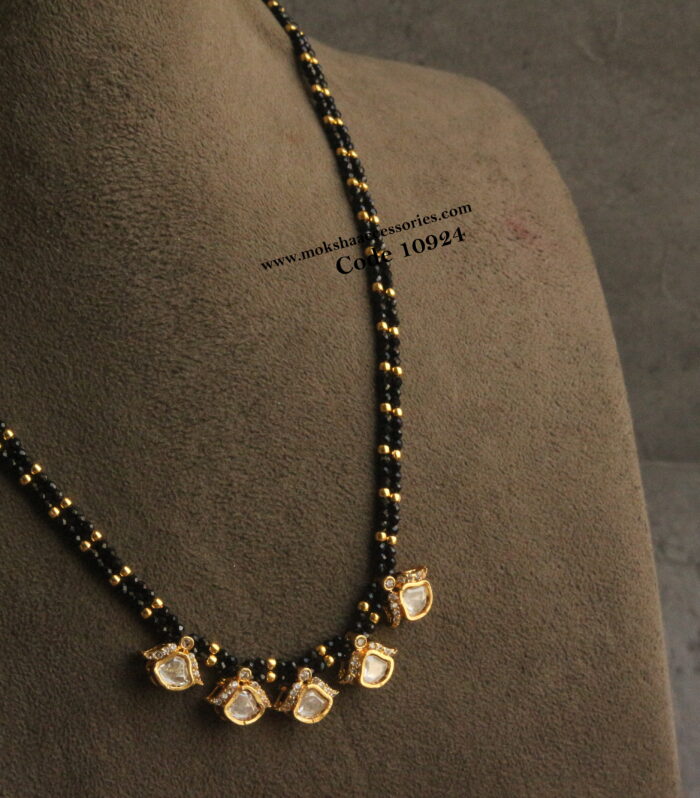 Black beads with mozonite stone pendants and gold balls