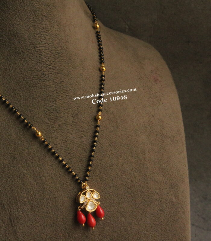 Mozonite stone pendant with corals and black beads