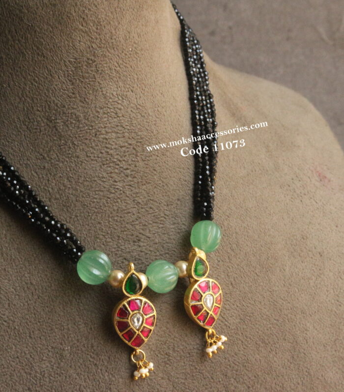 Jadaukundan pendants with pumpkin beads and black beads