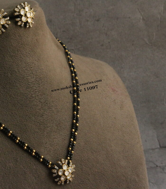 Mozonite stone pendant set with black beads and gold balls